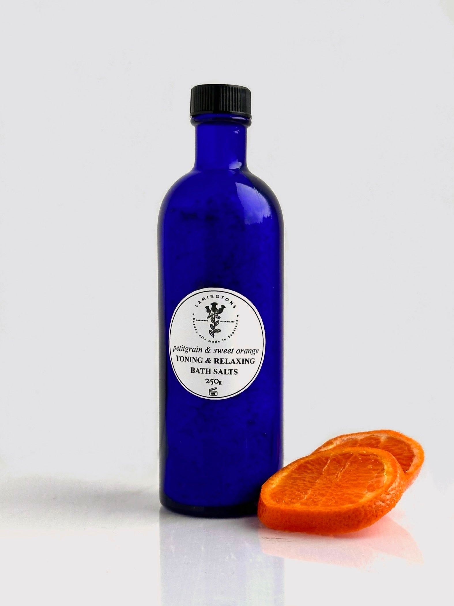 A bottle of petitgrain and sweet orange toning and relaxing bath salts.