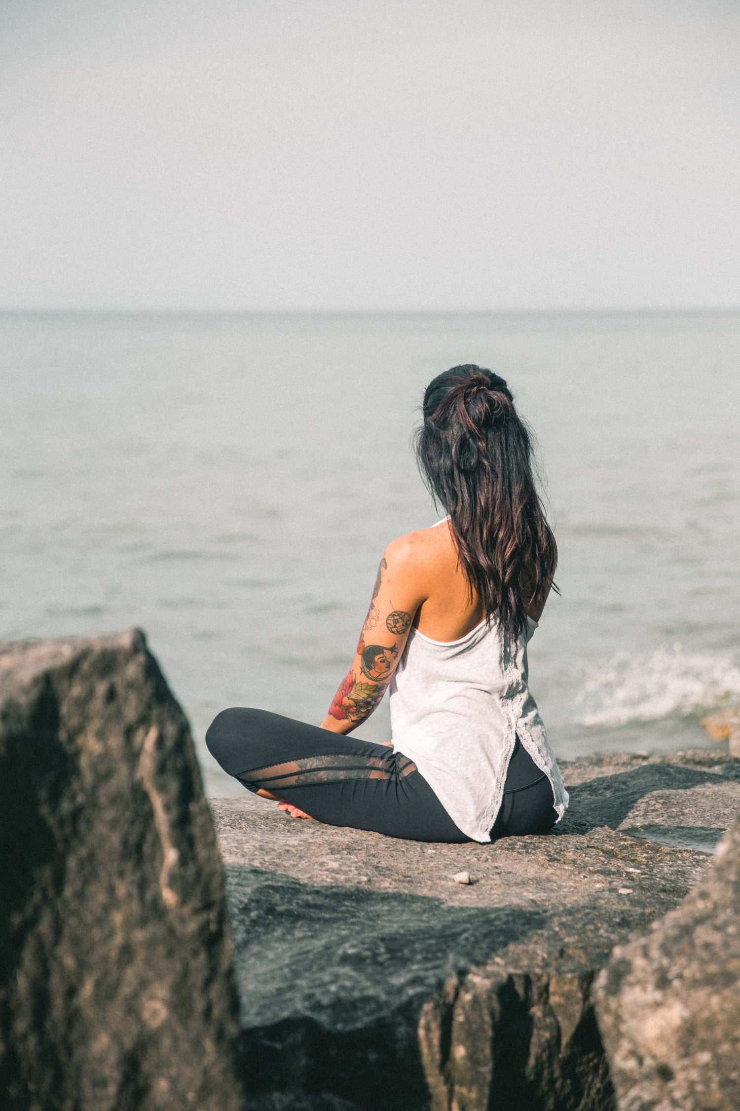 A woman meditating and living a life of sustainable and natural beauty.